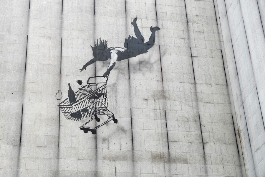Graffiti of a shopping cart falling